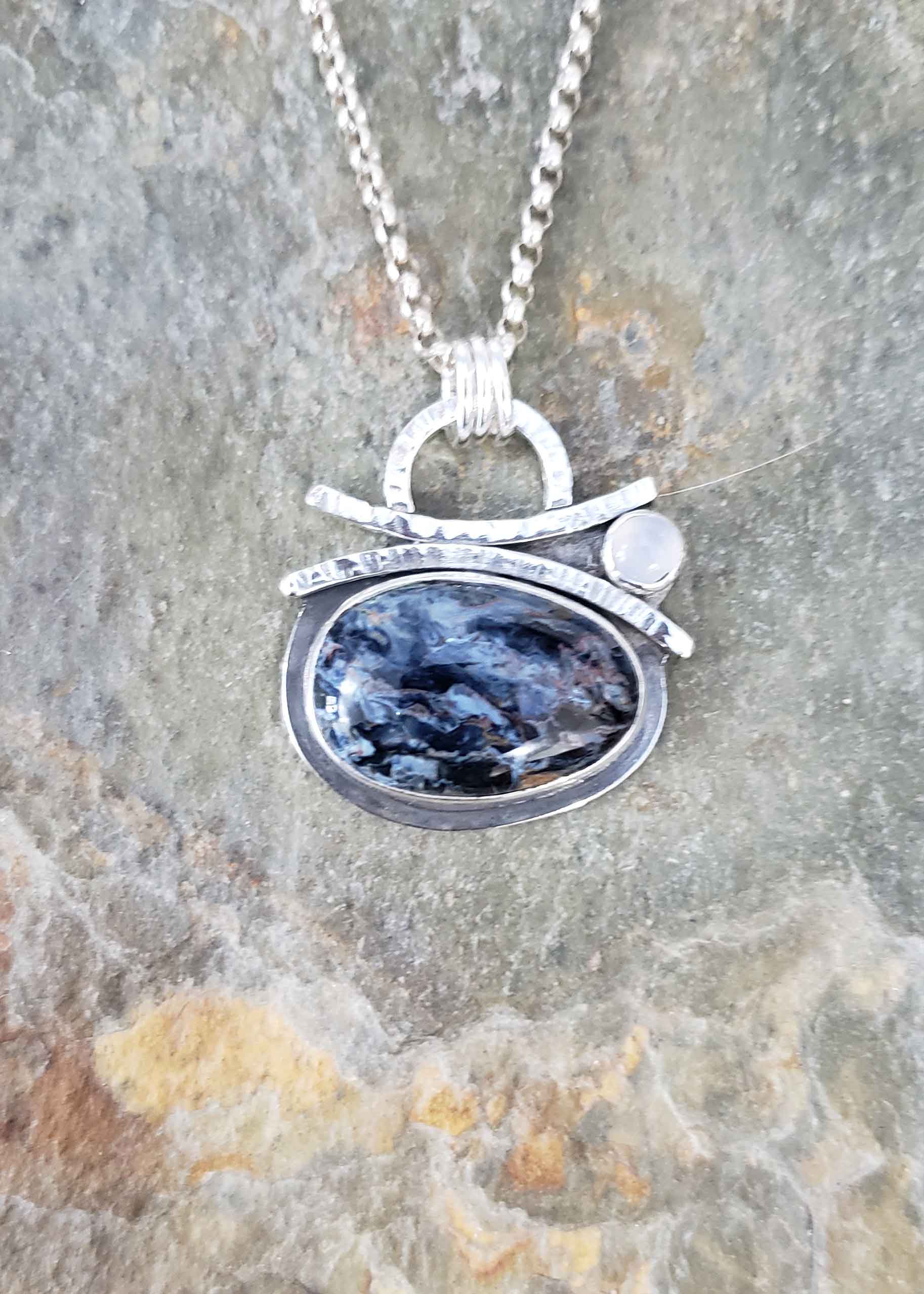 Deep ocean blues and light blue moon silver pendant by Dona Miller.