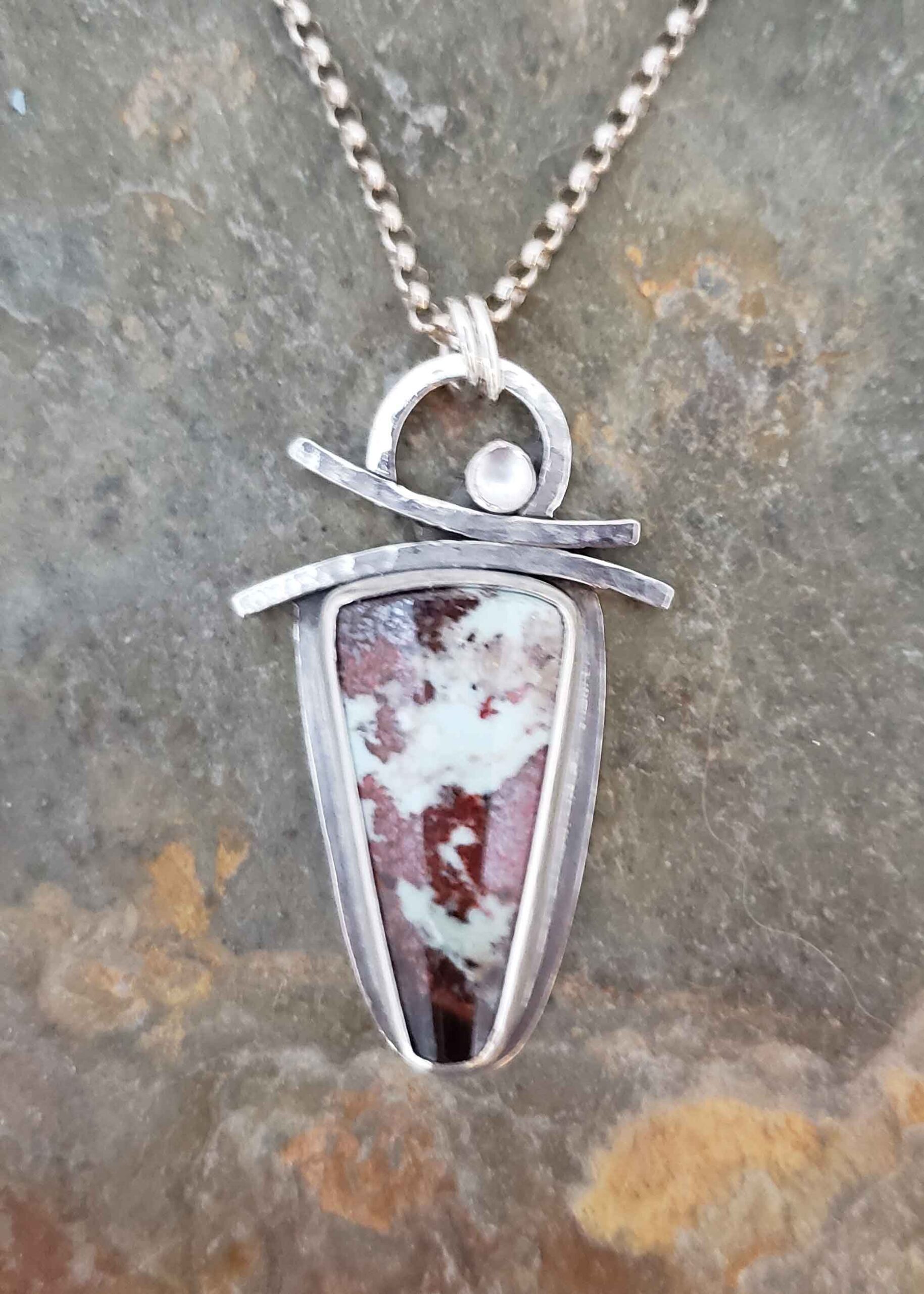 Red and white silver pendant by Dona Miller.