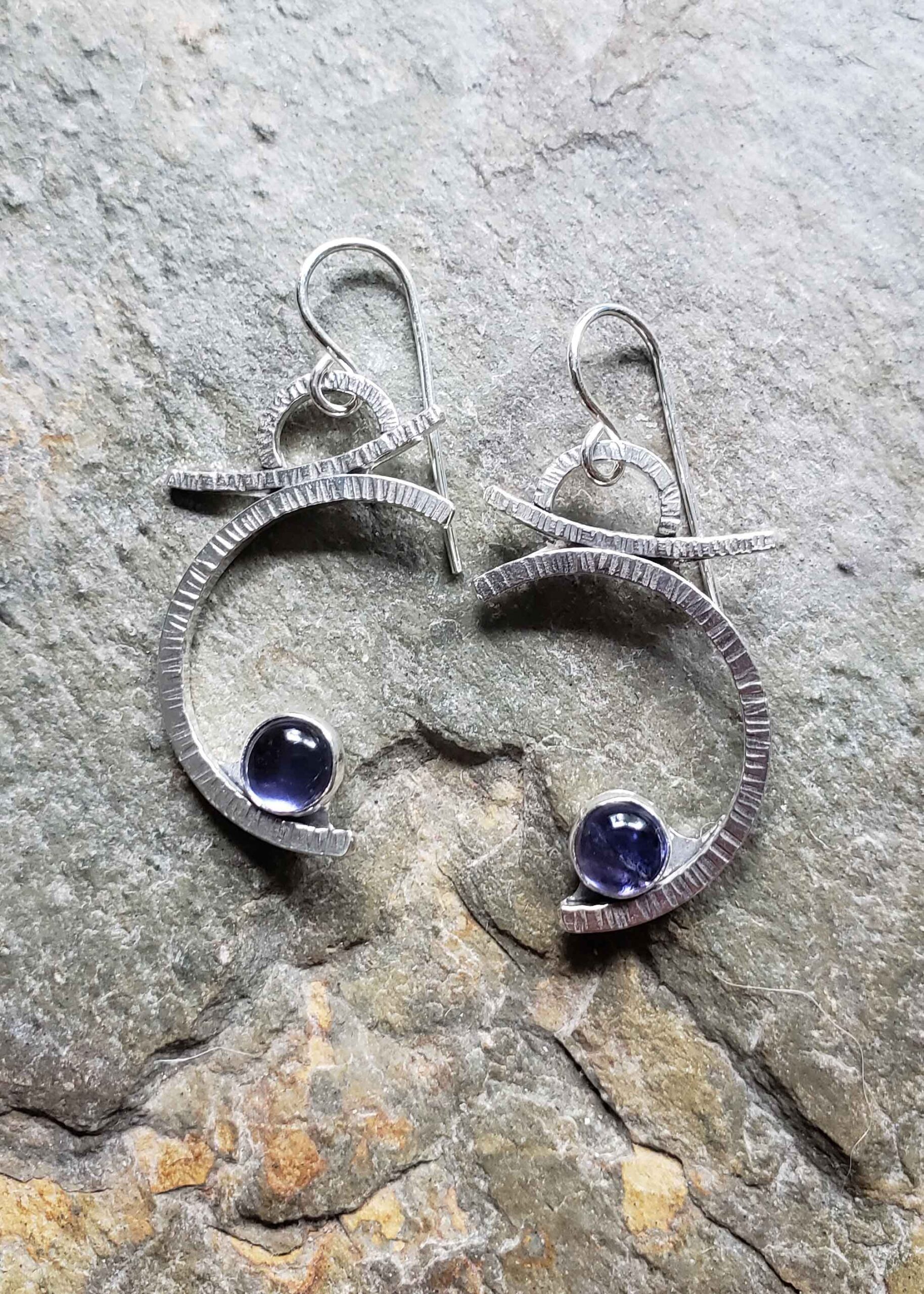 Silver earrings honoring the blue moon and the dreams we keep by Dona Miller.