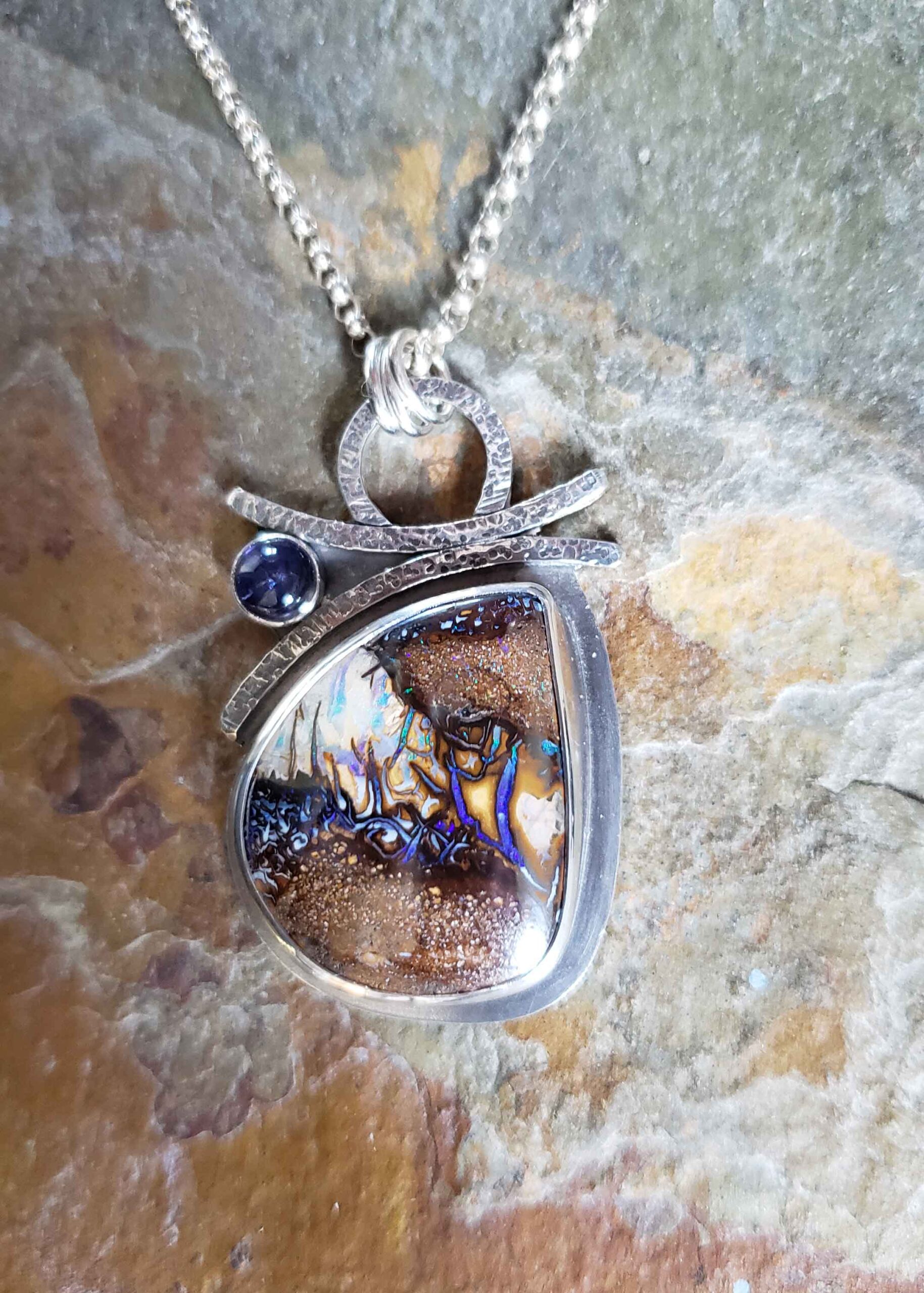 Silver boulder opal pendant in blues and browns by Dona Miller