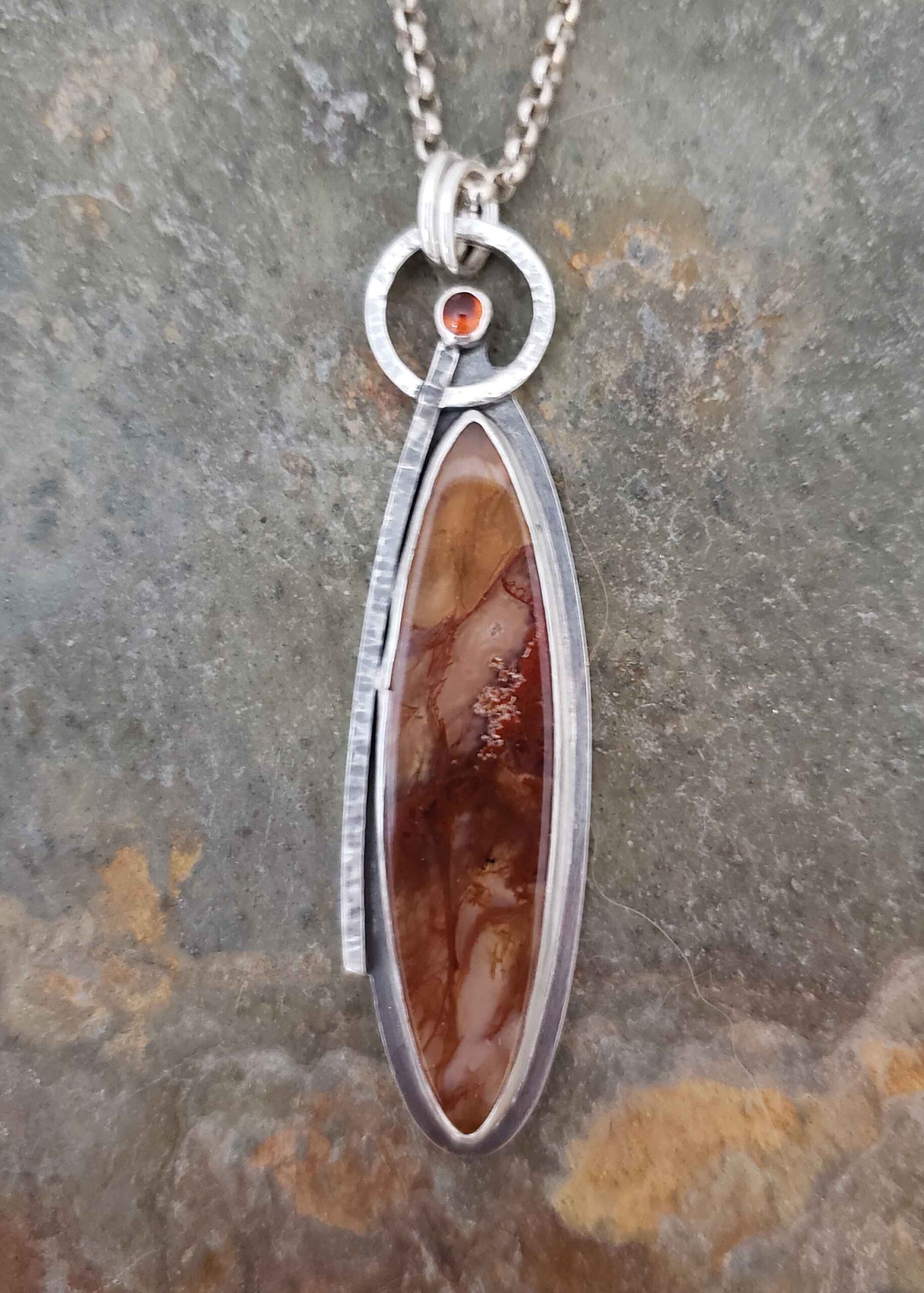 Warm browns and golden tones in this silver pendant by Dona Miller.