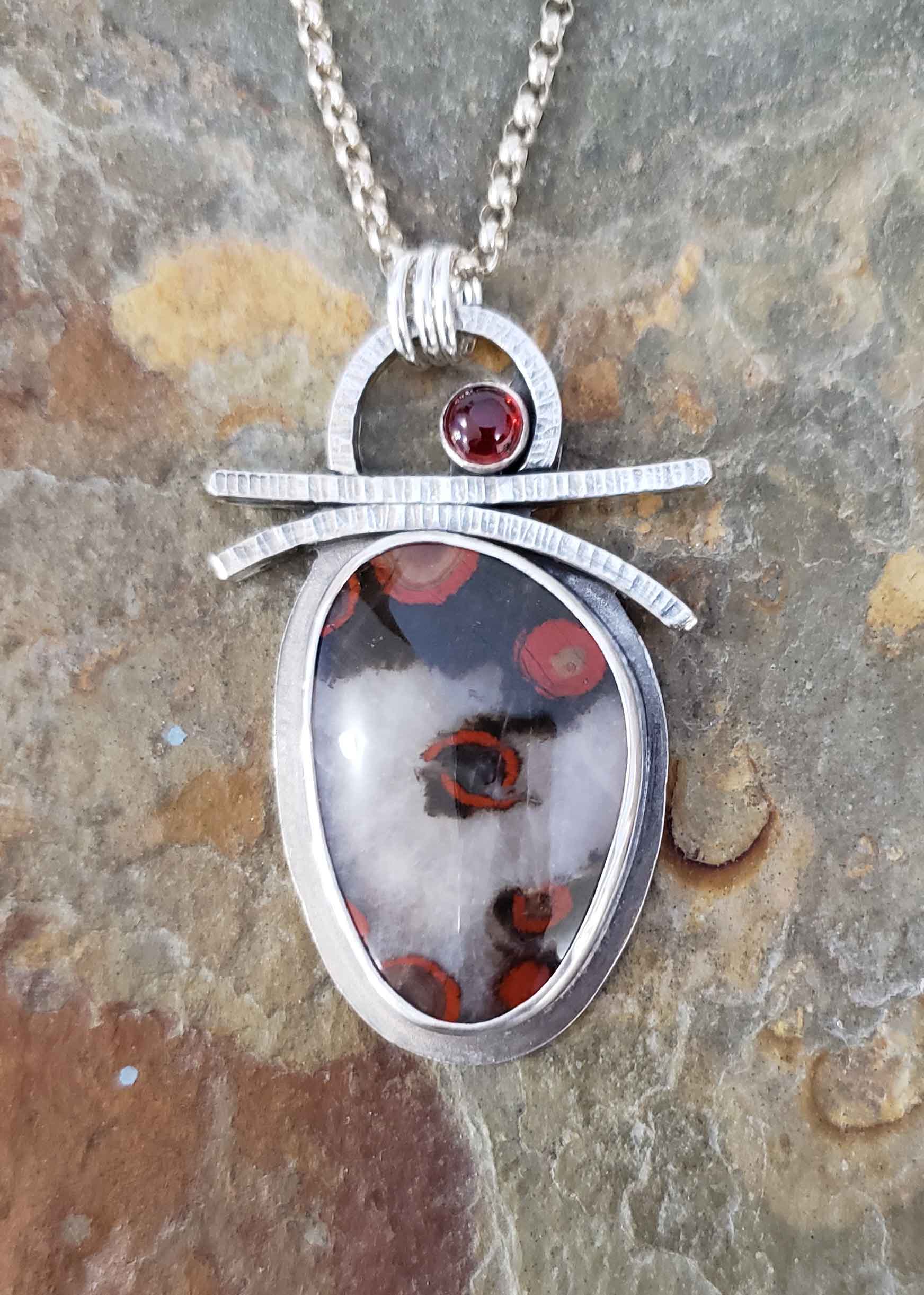 Red, black and white silver pendant by Dona Miller.