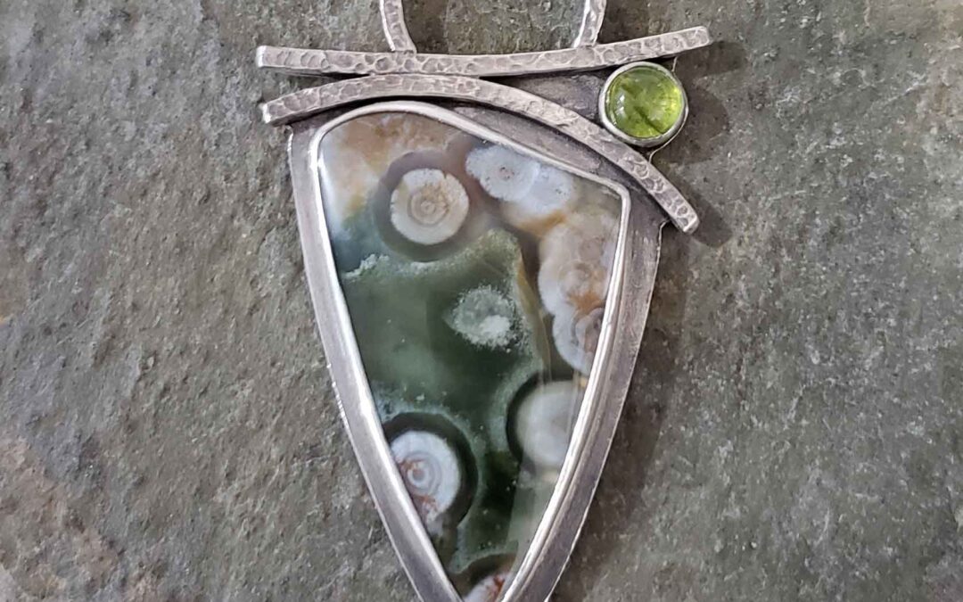 Greens, pinks and white in this silver pendant by Dona Miller.