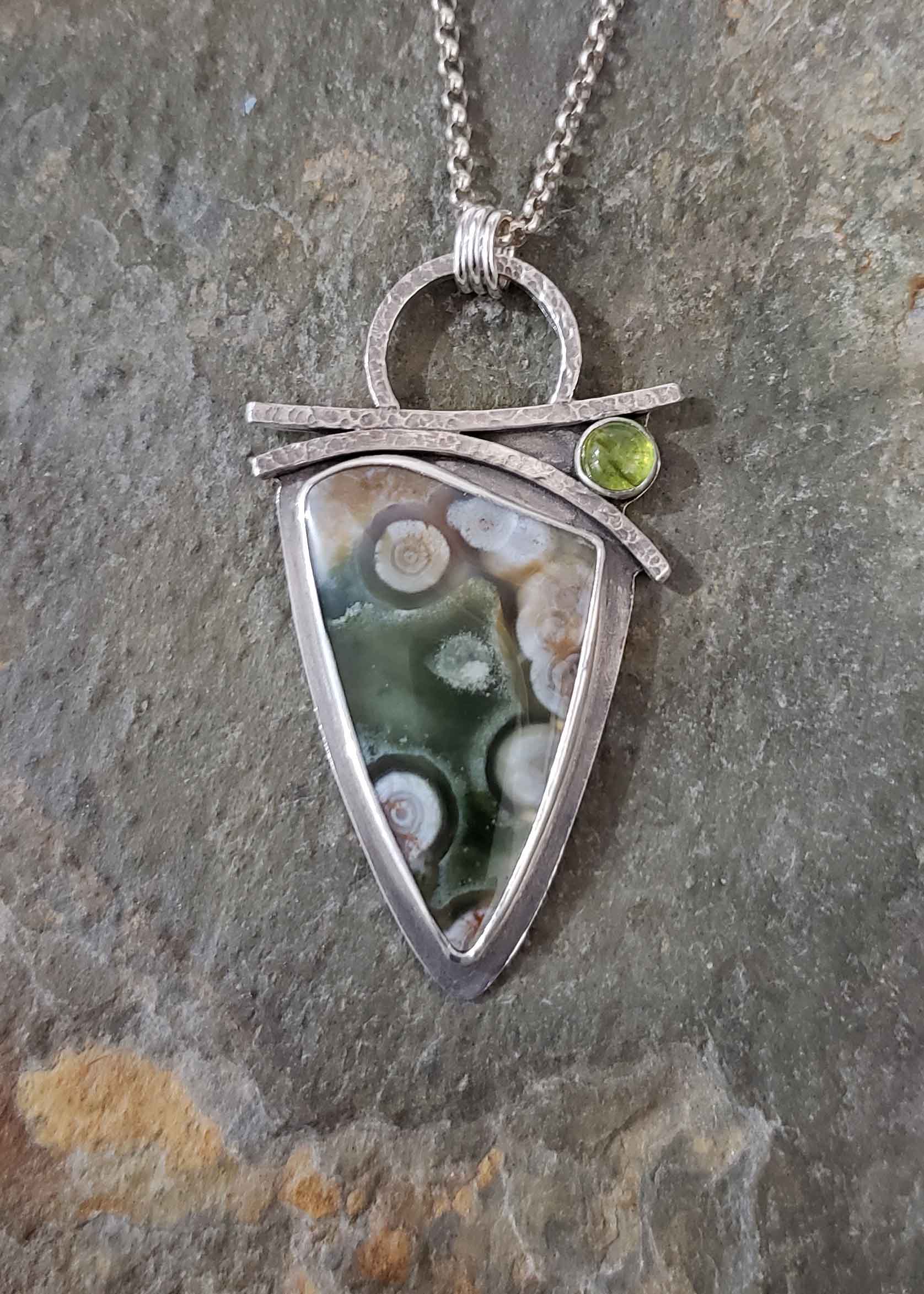 Greens, pinks and white in this silver pendant by Dona Miller.