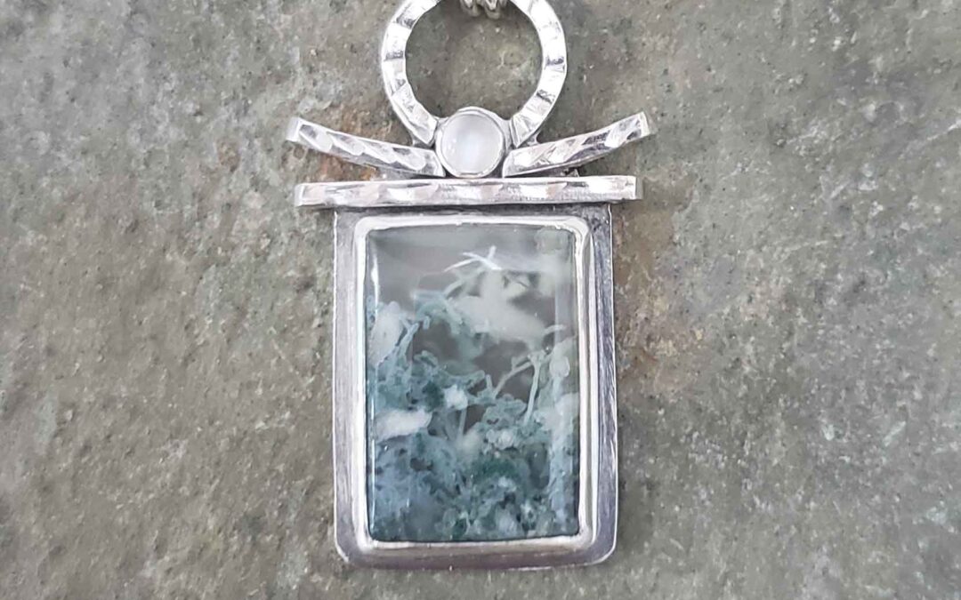Silver pendant in green and white agate and moonstone by Dona Miller.