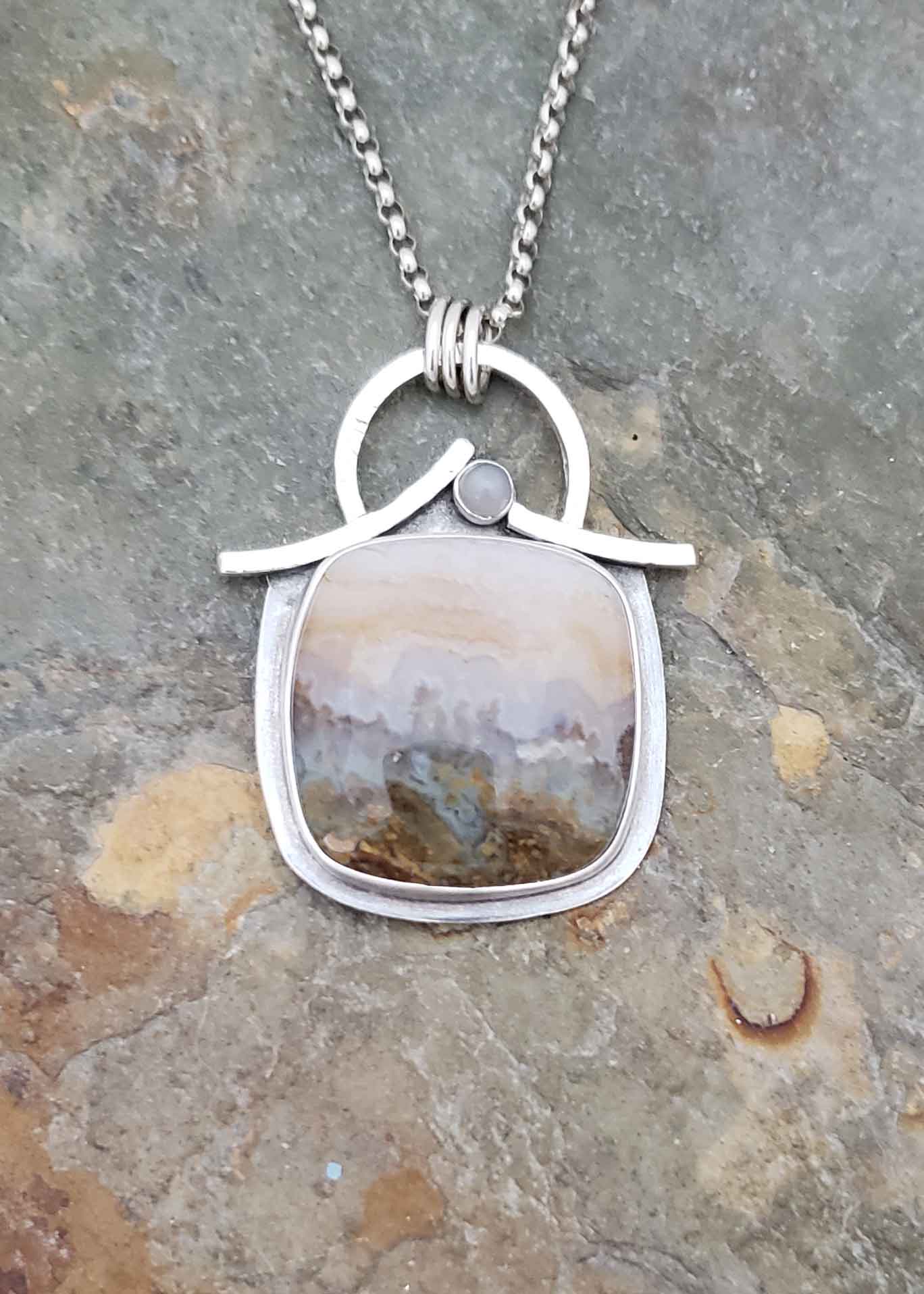 Grays and browns agate with silver Moonstone pendant.