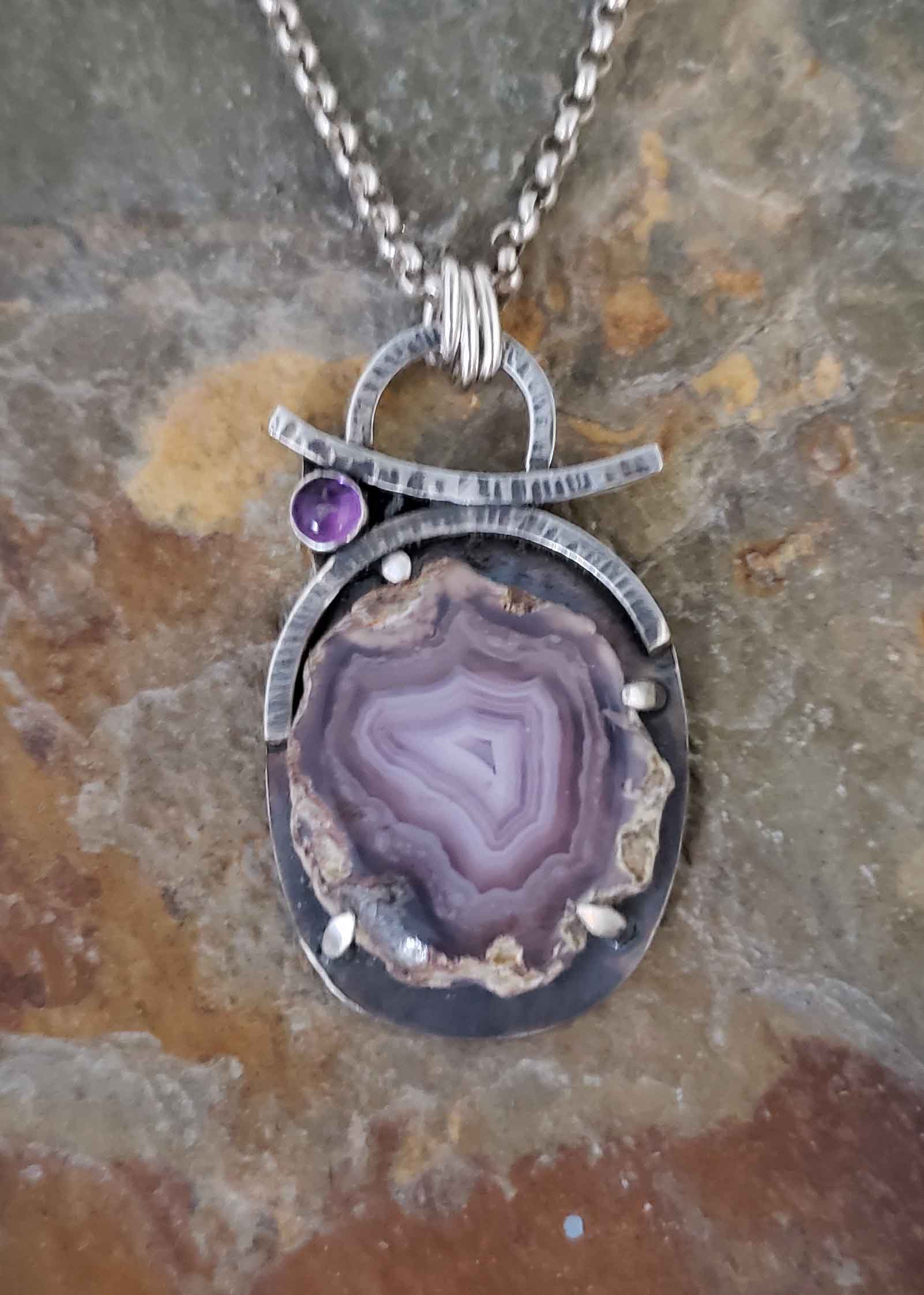Soft purples in this crystal slice silver pendant accented with amethyst by Dona Miller