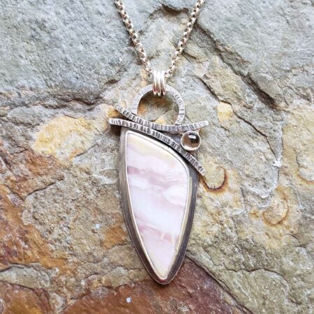 Soft pinks and browns in this silver pendant.