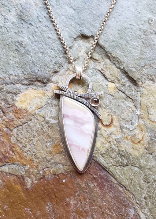Soft pinks and browns in this silver pendant.