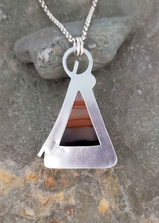 Pyramid strength in this ornage and black pendant.