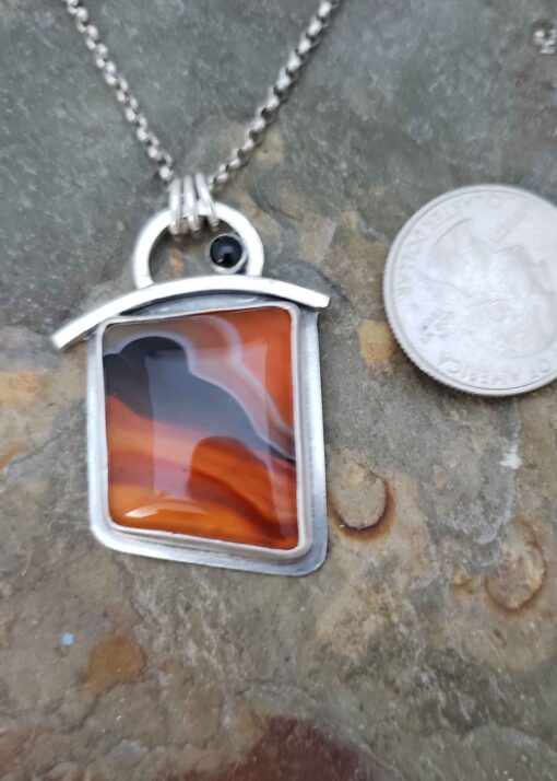 Warm tangerine oranges and black pendant in Bumblebee Chalcedony and Black Spinel.