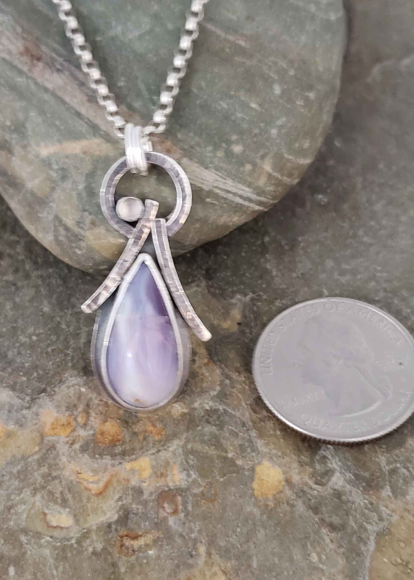 lavender holley chalcedony paired with moonstone in silver angel pendant