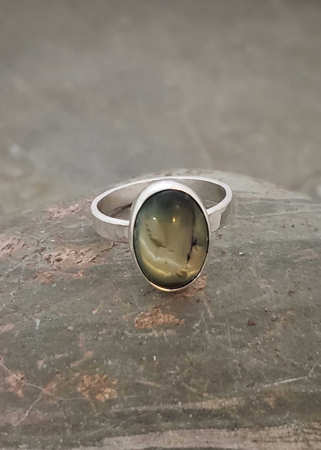 glow of olive green is captured in this silver ring, by Dona Miller 