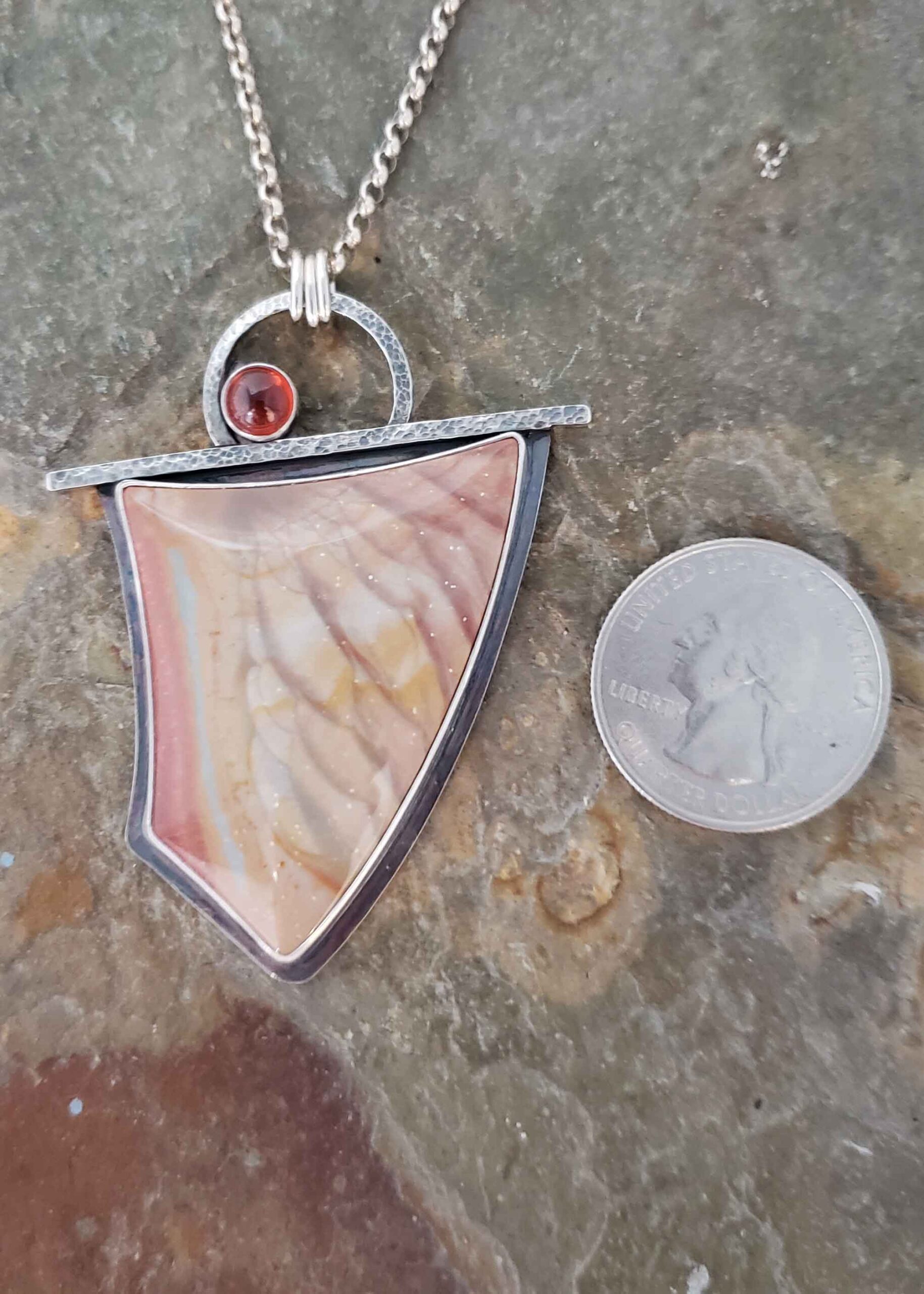 soft peach, creams and blues in this stone set in a silver pendant