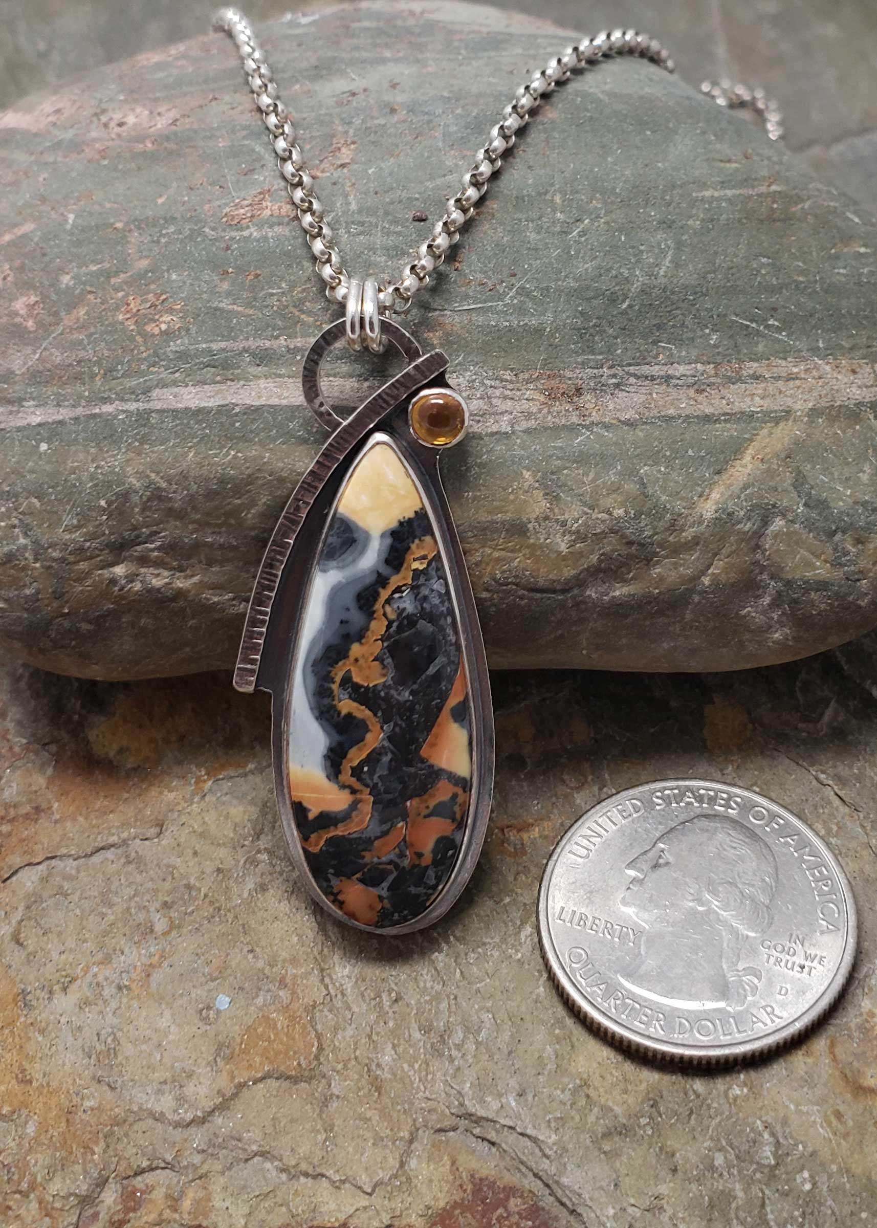 gold and blacks are featured in this sterling silver pendant of maligano jasper and citrine
