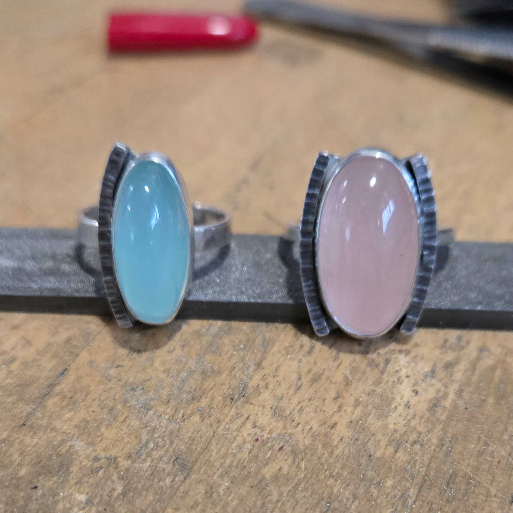 Silver rings in blue and pink, sea foam chalcedony and rose quartz. By Dona Miller